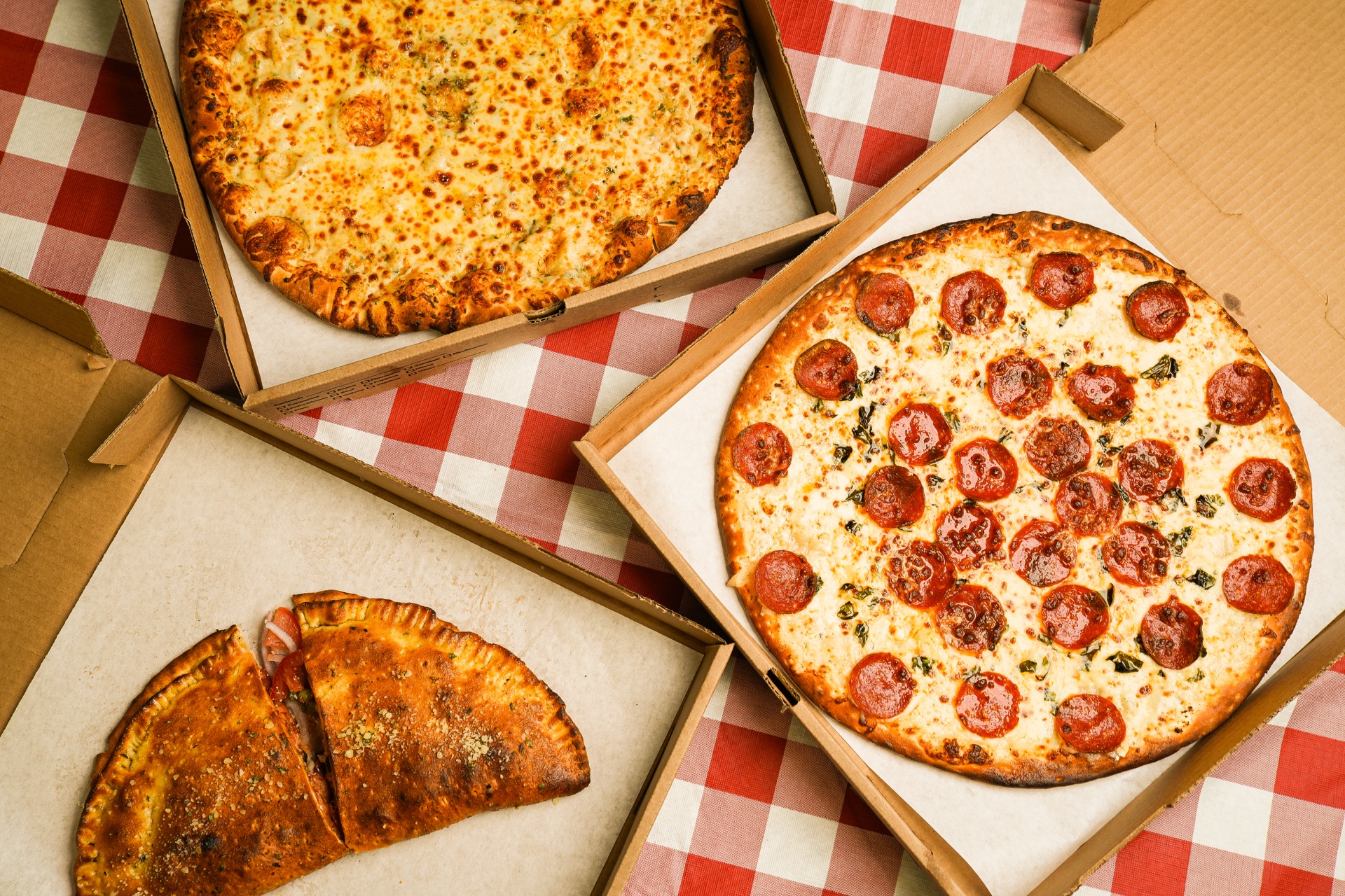 Rock Creek Pizza Co pizza on a wooden board, loaded with toppings